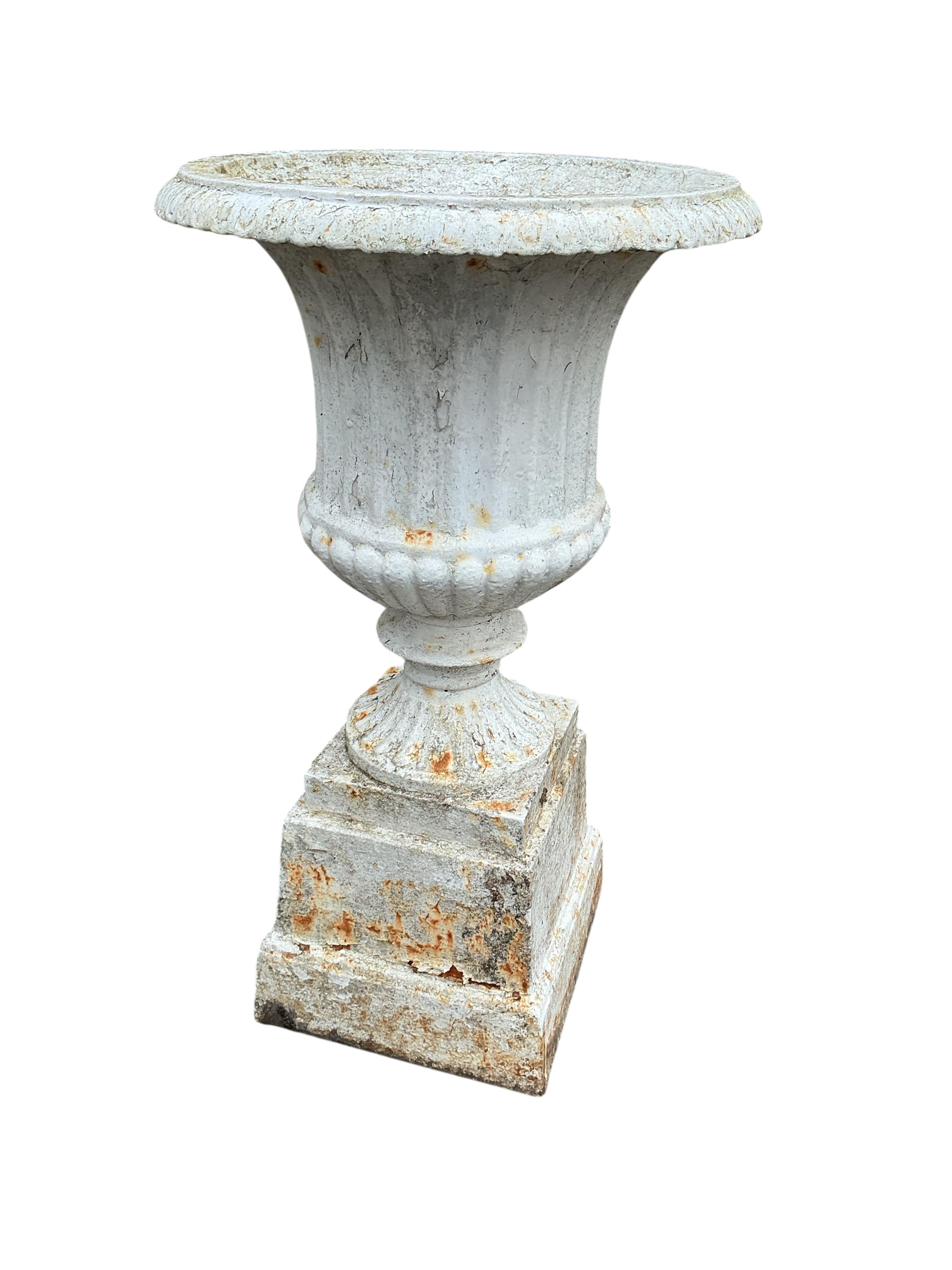 A pair of Victorian cast iron campana garden urns, on square bases, diameter 38cm, height 69cm